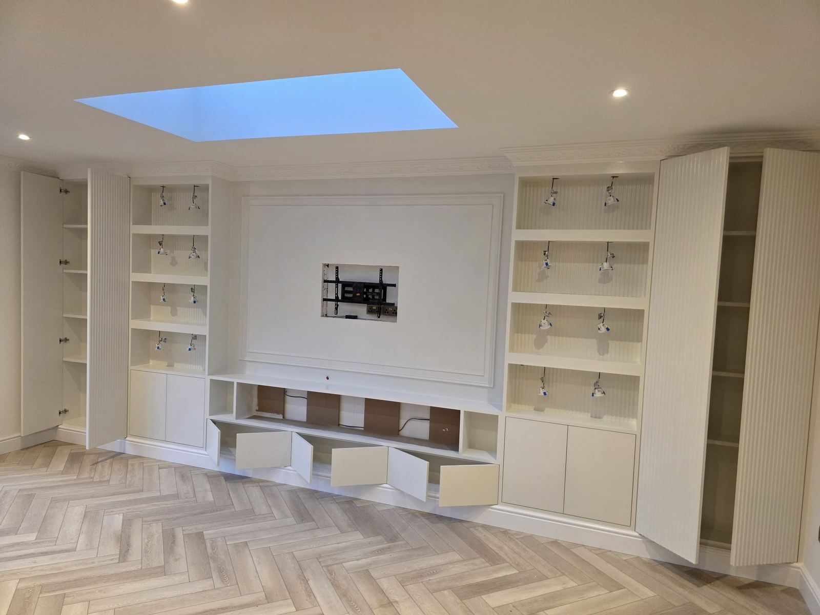 After — bespoke entertainment wall with reeded columns, panelling and off-white paint finish