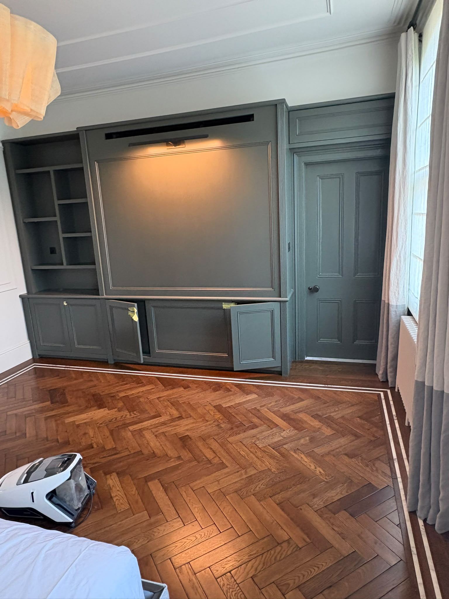 Bedroom media wall with green cabinetry, Edgware