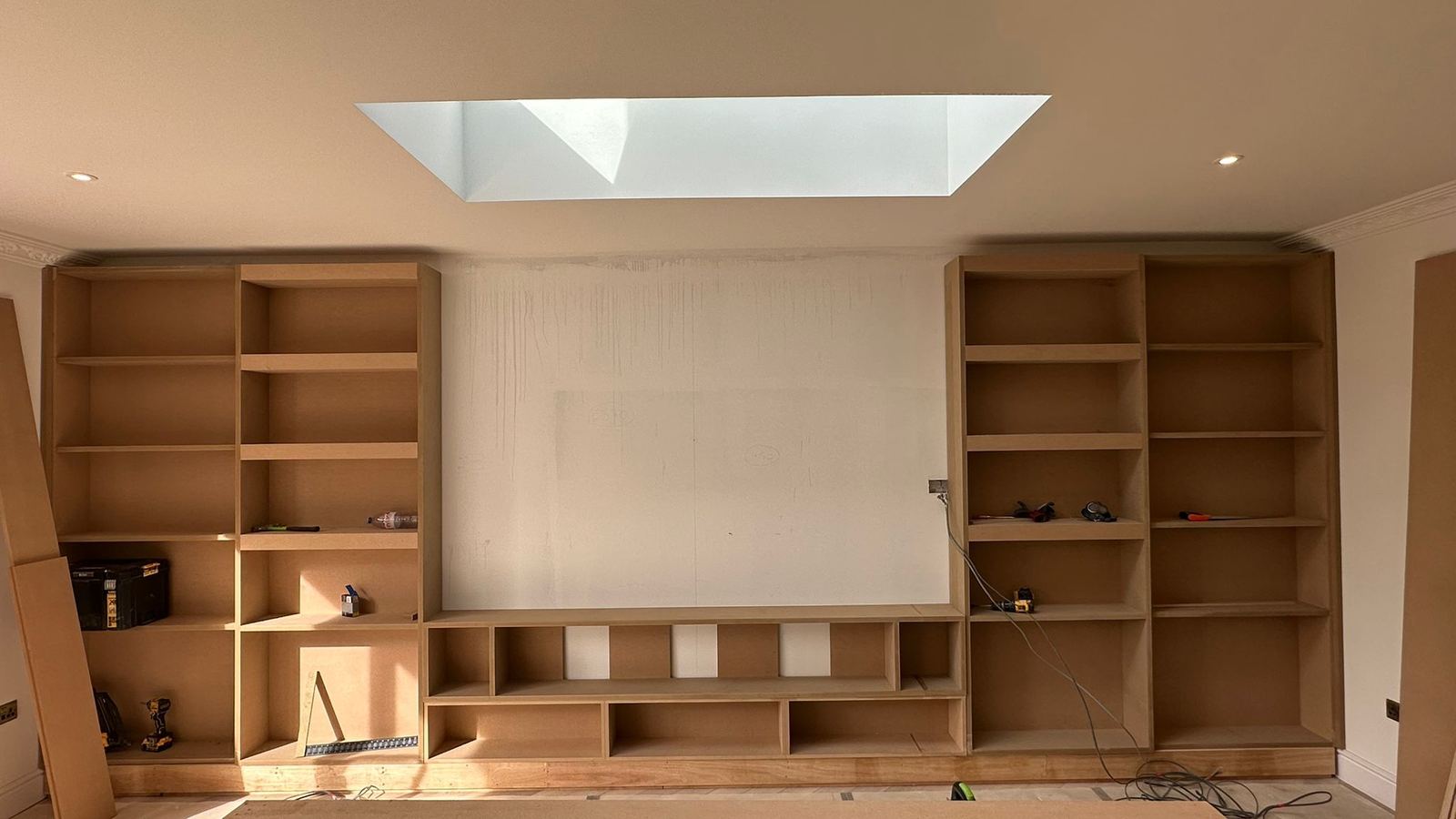 Before — bare MDF fitted shelving units awaiting decoration
