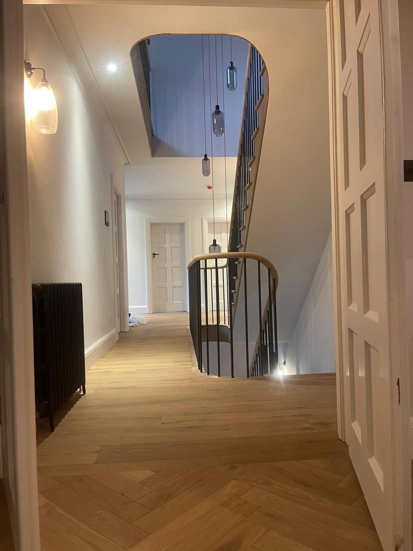 Curved Staircase with Red Cable Pendants