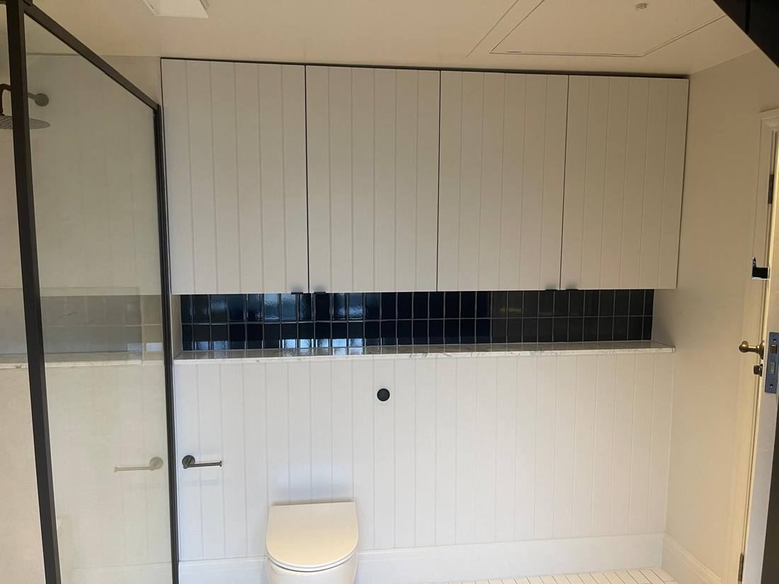 White Bathroom with Black Tile Band